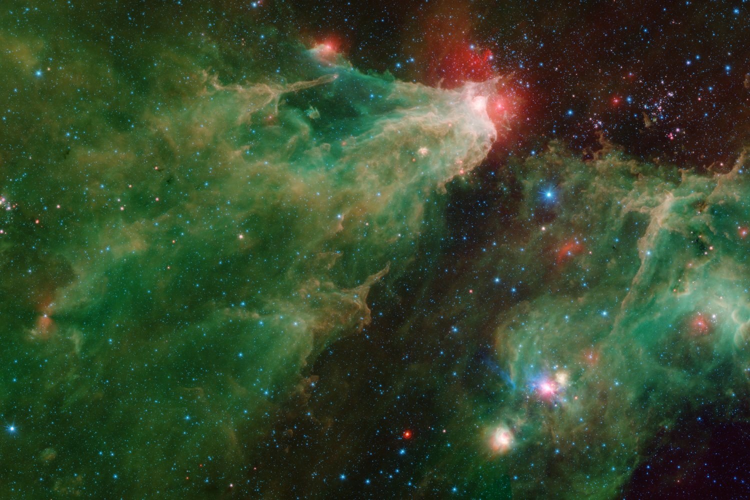 A long green cloud of gas with a bright red head, among stars, in false colour.