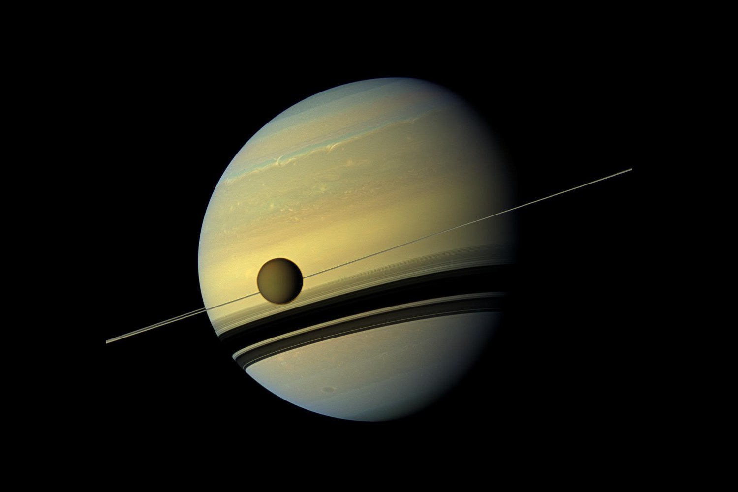 A small orange moon passing in front of a banded giant planet, the planet's rings a thin line across it.